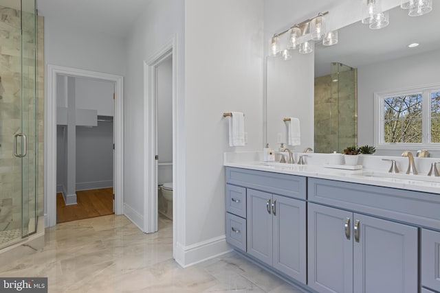 629 S Orange St, Media, PA 19063 - bathroom featuring a stall shower, double vanity, marble finish floors, and toilet