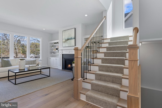629 S Orange St, Media, PA 19063 - living area featuring wood finished floors, stairs, a fireplace with flush hearth, and recessed lighting