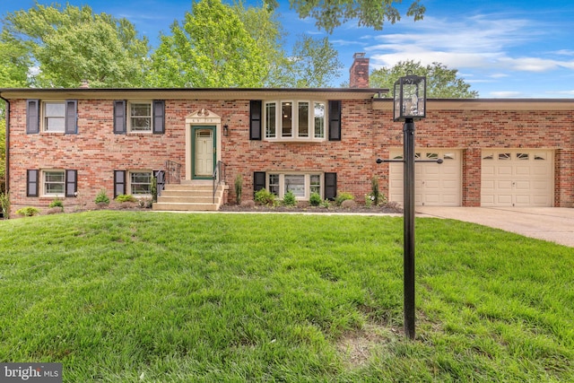 6913 Fulford St, Clinton, MD 20735 - bi-level home with driveway, a front lawn, a chimney, and brick siding