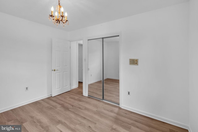 6913 Fulford St, Clinton, MD 20735 - unfurnished bedroom with a chandelier, baseboards, a closet, and light wood finished floors