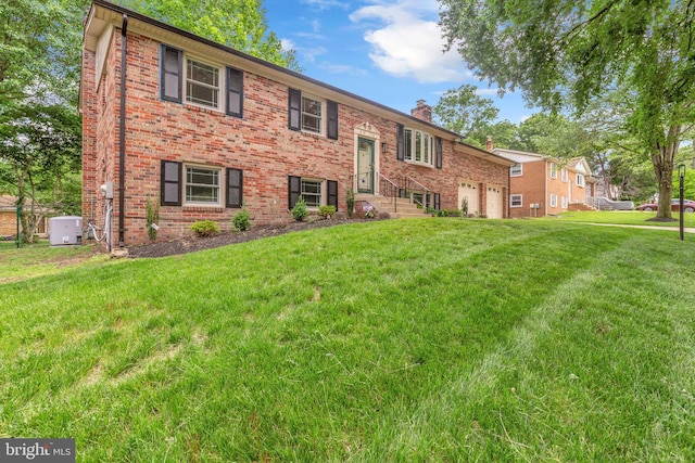6913 Fulford St, Clinton, MD 20735 - view of front of house featuring a chimney, brick siding, a front lawn, and an attached garage