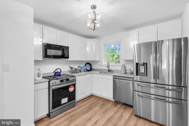 6913 Fulford St, Clinton, MD 20735 - kitchen with appliances with stainless steel finishes, a sink, white cabinetry, and light countertops