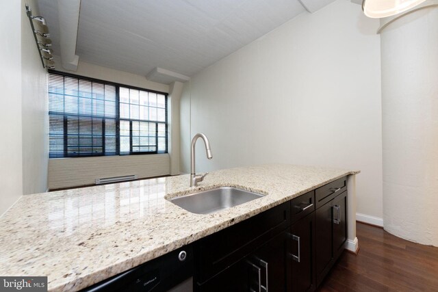 2429 Locust St Unit 319, Philadelphia, PA 19103 - kitchen featuring a sink, dark wood finished floors, light stone counters, and dark cabinets