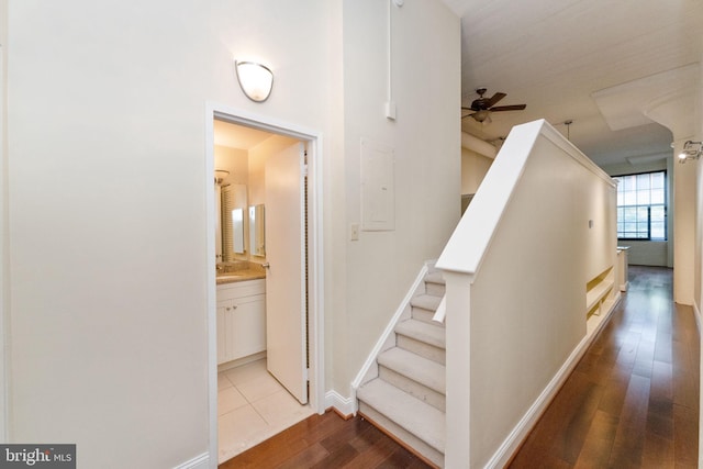 2429 Locust St Unit 319, Philadelphia, PA 19103 - staircase with wood finished floors, a ceiling fan, and baseboards