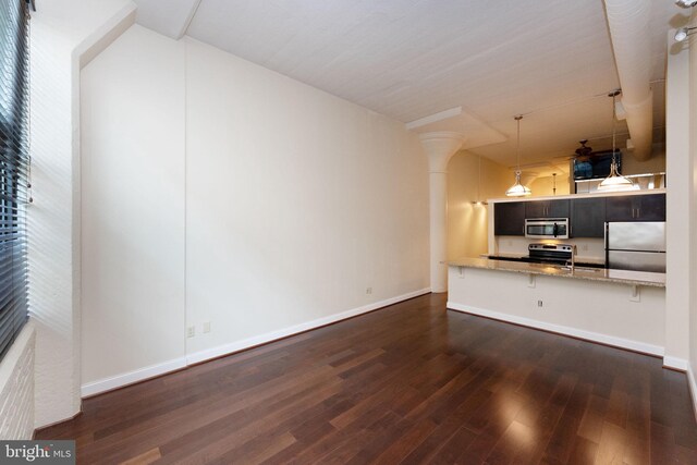 2429 Locust St Unit 319, Philadelphia, PA 19103 - unfurnished living room with decorative columns, dark wood-style floors, baseboards, and a sink
