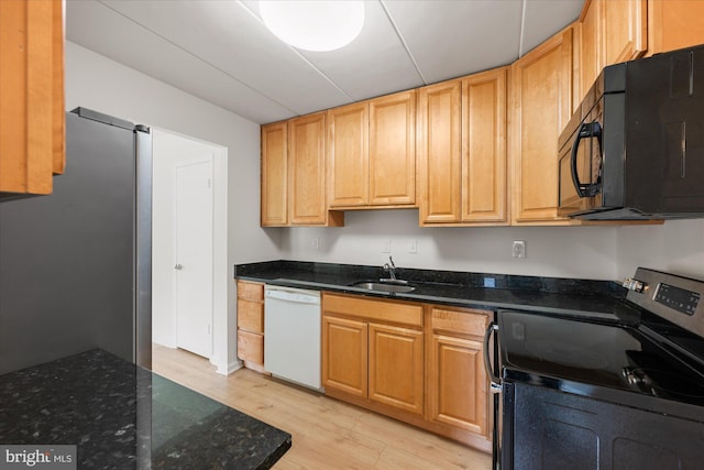 6270 Edsall Rd Unit 101, Alexandria, VA 22312 - kitchen featuring appliances with stainless steel finishes, light wood-type flooring, a sink, and dark stone countertops