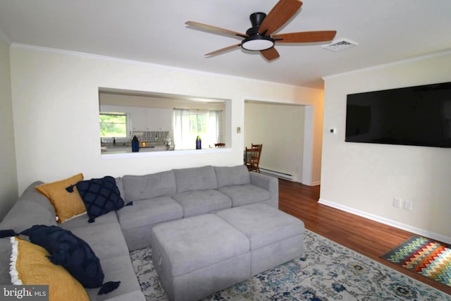 17 Greenridge Ave, Ridgely, MD 21660 - living room featuring baseboard heating, wood finished floors, crown molding, ceiling fan, and baseboards