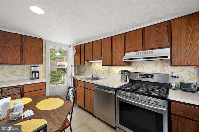 104 11th St, Ocean City, MD 21842 - kitchen with appliances with stainless steel finishes, ventilation hood, a sink, and light countertops