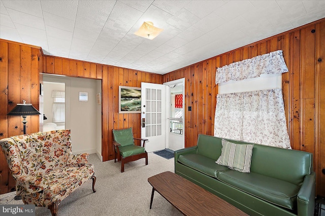 104 11th St, Ocean City, MD 21842 - living area featuring wooden walls, carpet flooring, and healthy amount of natural light