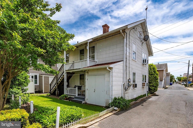 104 11th St, Ocean City, MD 21842 - rear view of property featuring a chimney, stairs, and a lawn