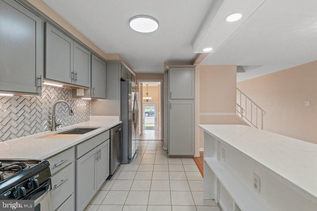 911 Circle Dr, Baltimore, MD 21227 - kitchen featuring gray cabinets, a sink, stainless steel appliances, backsplash, and light tile patterned flooring