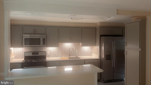 911 Circle Dr, Baltimore, MD 21227 - kitchen with appliances with stainless steel finishes, light countertops, gray cabinets, and tasteful backsplash