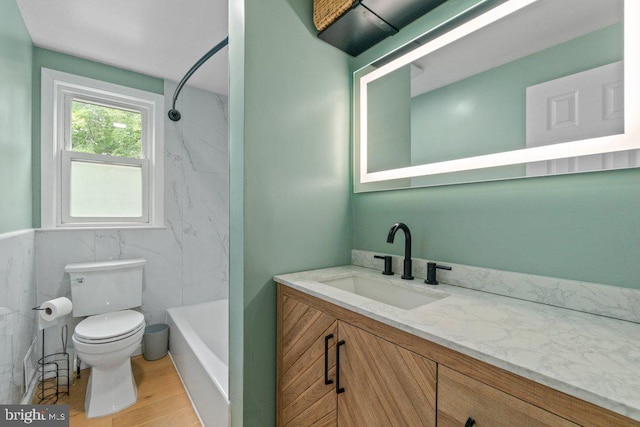 911 Circle Dr, Baltimore, MD 21227 - full bath featuring toilet, vanity, wood finished floors, and shower / bathtub combination