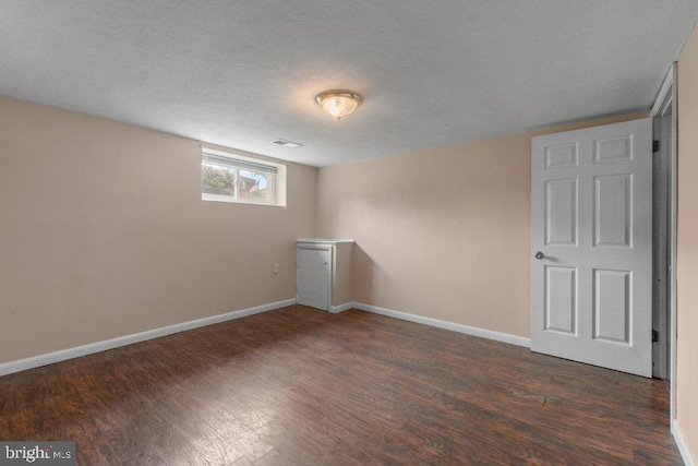 911 Circle Dr, Baltimore, MD 21227 - basement with wood finished floors, baseboards, and a textured ceiling
