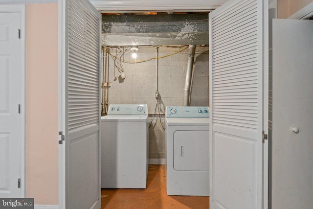 911 Circle Dr, Baltimore, MD 21227 - laundry room featuring separate washer and dryer and concrete block wall