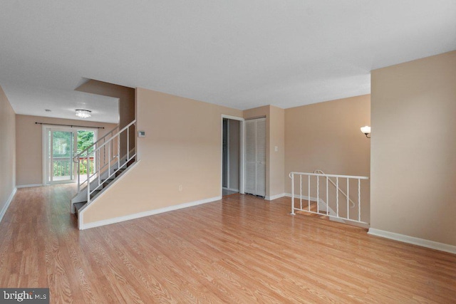 911 Circle Dr, Baltimore, MD 21227 - unfurnished room featuring wood finished floors, baseboards, and stairs
