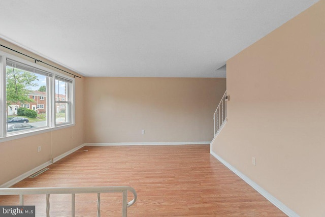 911 Circle Dr, Baltimore, MD 21227 - unfurnished room featuring light wood-style floors, baseboards, and stairs