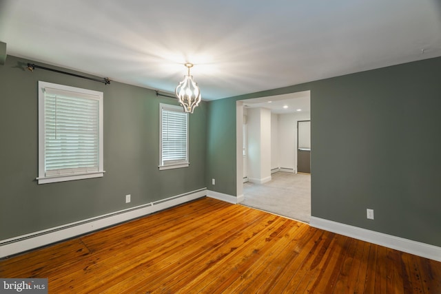 131 Main, Medford, NJ 08055 - empty room with baseboard heating, a chandelier, wood-type flooring, baseboards, and a baseboard radiator