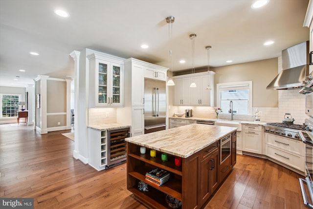 2371 N Edgewood St, Arlington, VA 22207 - kitchen featuring open shelves, wine cooler, stainless steel appliances, wall chimney range hood, and white cabinetry