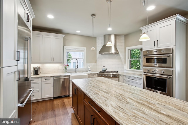 2371 N Edgewood St, Arlington, VA 22207 - kitchen featuring stainless steel appliances, wall chimney exhaust hood, a sink, tasteful backsplash, and recessed lighting