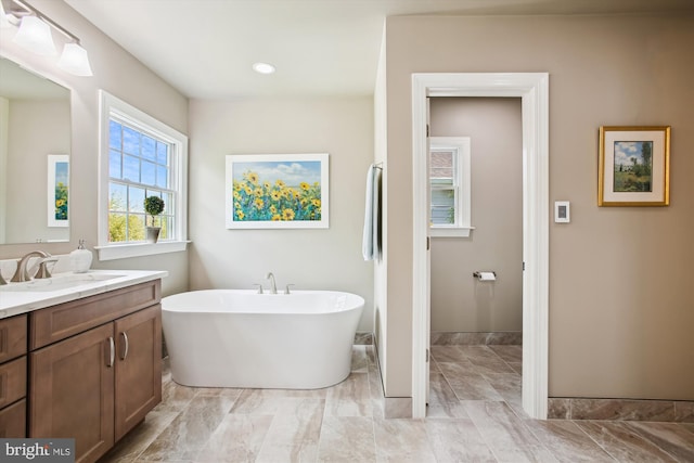 2371 N Edgewood St, Arlington, VA 22207 - bathroom with vanity, a freestanding tub, and baseboards