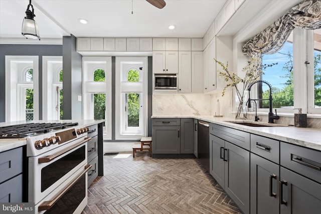 1202 W Wynnewood Rd Unit 1, Wynnewood, PA 19096 - kitchen with gray cabinets, stainless steel appliances, a sink, recessed lighting, and backsplash