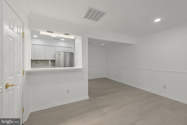 20036 Appledowre Cir Unit 450, Germantown, MD 20876 - spare room featuring light wood-type flooring, crown molding, recessed lighting, and baseboards