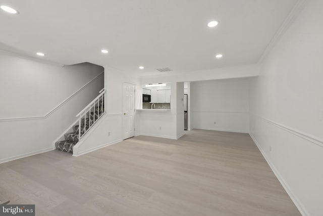 20036 Appledowre Cir Unit 450, Germantown, MD 20876 - unfurnished living room with stairway, recessed lighting, light wood-style floors, baseboards, and crown molding
