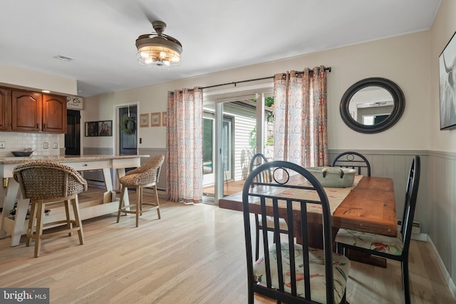 105 Stonewyck Dr, Lancaster, PA 17603 - dining room with light wood-style floors, a wainscoted wall, and a baseboard heating unit