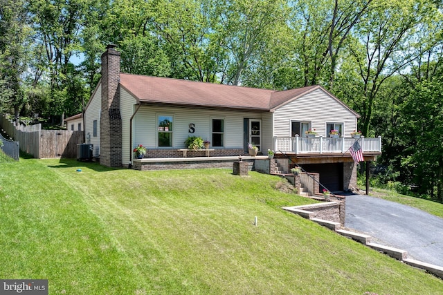 105 Stonewyck Dr, Lancaster, PA 17603 - ranch-style home with asphalt driveway, a wooden deck, a garage, a chimney, and cooling unit