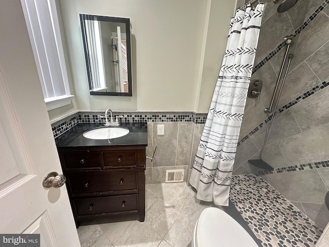 8854 Calvert St, Philadelphia, PA 19152 - bathroom featuring tile walls, a shower stall, vanity, toilet, and wainscoting