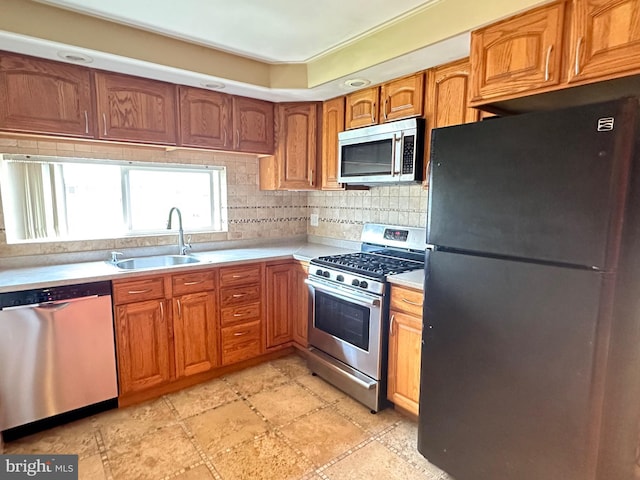 8854 Calvert St, Philadelphia, PA 19152 - kitchen with stainless steel appliances, a sink, light countertops, decorative backsplash, and brown cabinetry