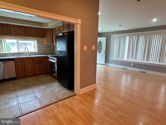 8854 Calvert St, Philadelphia, PA 19152 - kitchen with stainless steel appliances, light wood-type flooring, baseboards, brown cabinets, and recessed lighting