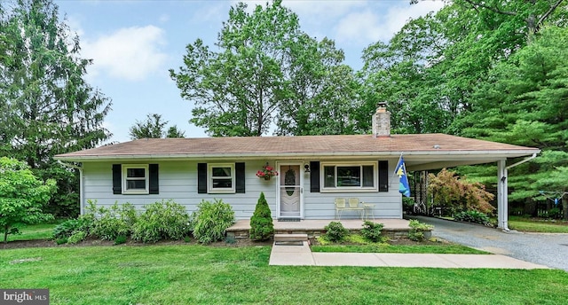 2122 Harkins Rd, Pylesville, MD 21132 - view of front of home with asphalt driveway, a front yard, a chimney, an attached carport, and covered porch