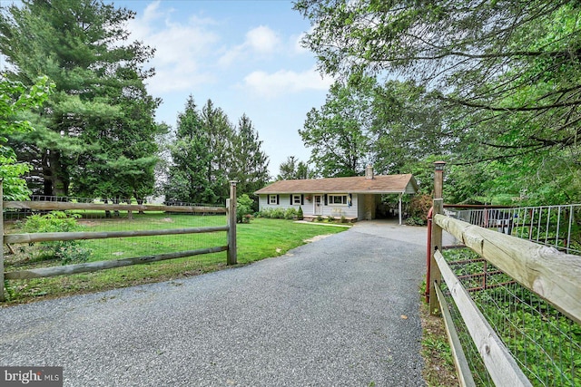 2122 Harkins Rd, Pylesville, MD 21132 - single story home with driveway, a chimney, and an attached carport