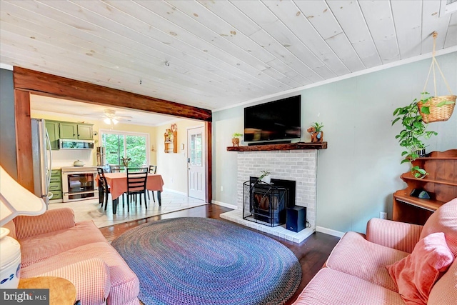 2122 Harkins Rd, Pylesville, MD 21132 - living area featuring wood finished floors, baseboards, wood ceiling with exposed beams, a fireplace, and ceiling fan