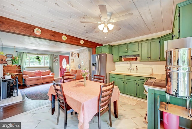 2122 Harkins Rd, Pylesville, MD 21132 - dining area with wood ceiling, a wood stove, light tile patterned floors, and a ceiling fan
