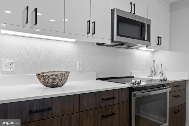 919 12th St NE Unit 201, Washington, DC 20002 - kitchen featuring appliances with stainless steel finishes, modern cabinets, light countertops, backsplash, and white cabinets