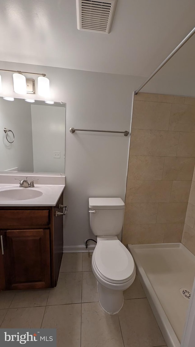 104 Duvall Ln Unit 30-104, Gaithersburg, MD 20877 - bathroom with a stall shower, toilet, vanity, tile patterned floors, and baseboards