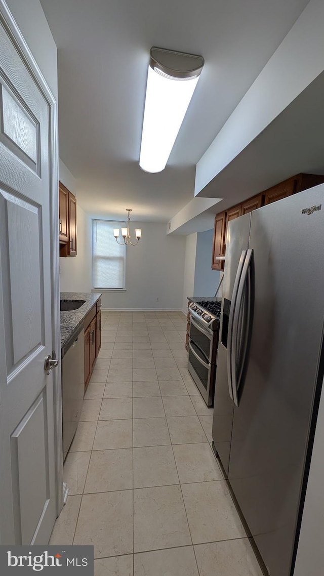 104 Duvall Ln Unit 30-104, Gaithersburg, MD 20877 - kitchen with appliances with stainless steel finishes, a chandelier, brown cabinetry, and light tile patterned floors