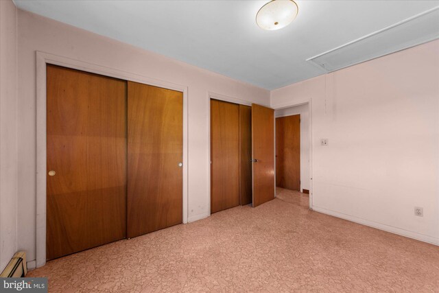 2138 Hill Rd, Perkiomenville, PA 18074 - unfurnished bedroom featuring attic access, multiple closets, baseboard heating, and baseboards