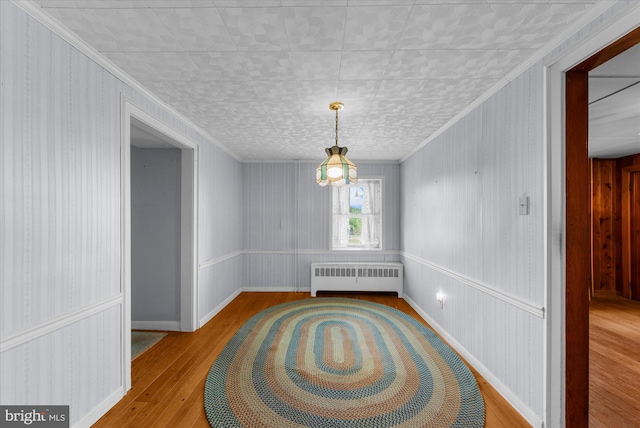 2138 Hill Rd, Perkiomenville, PA 18074 - unfurnished dining area featuring radiator, wood finished floors, and ornamental molding