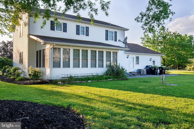 14 N Horseshoe Dr, Milford, DE 19963 - rear view of house featuring a lawn, a sunroom, and cooling unit