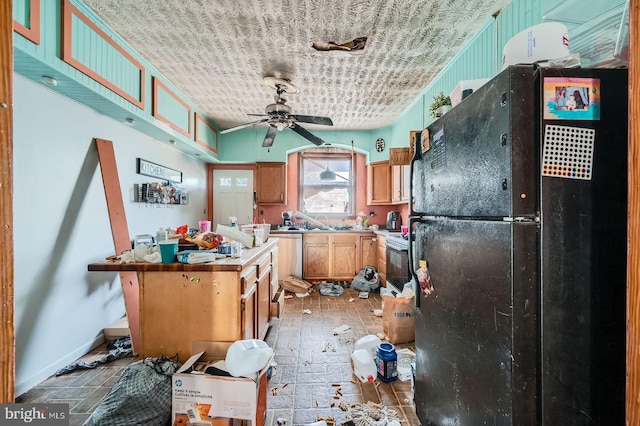 12 Kresson St N, Baltimore, MD 21224 - kitchen with freestanding refrigerator, a ceiling fan, white range with electric stovetop, and light countertops
