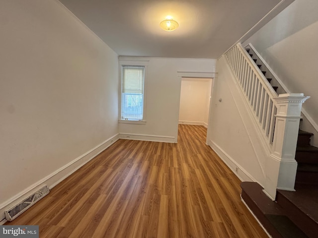 423 Trenton Ave, Camden, NJ 08103 - unfurnished living room featuring wood finished floors, baseboards, and stairway