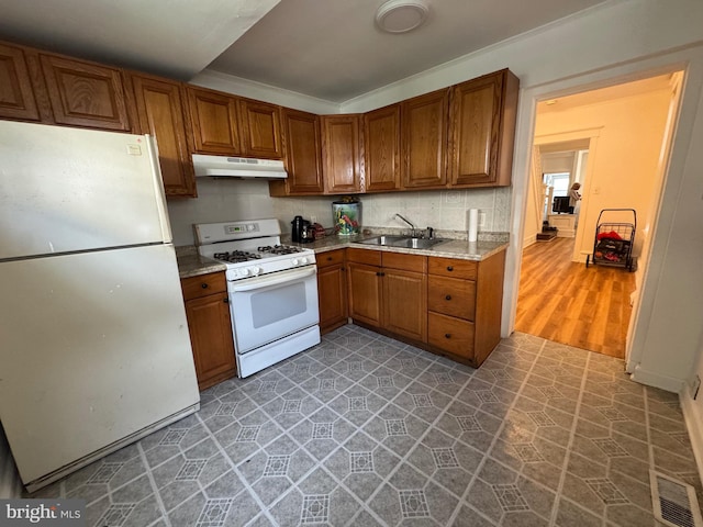 423 Trenton Ave, Camden, NJ 08103 - kitchen with white appliances, a sink, brown cabinetry, and light countertops