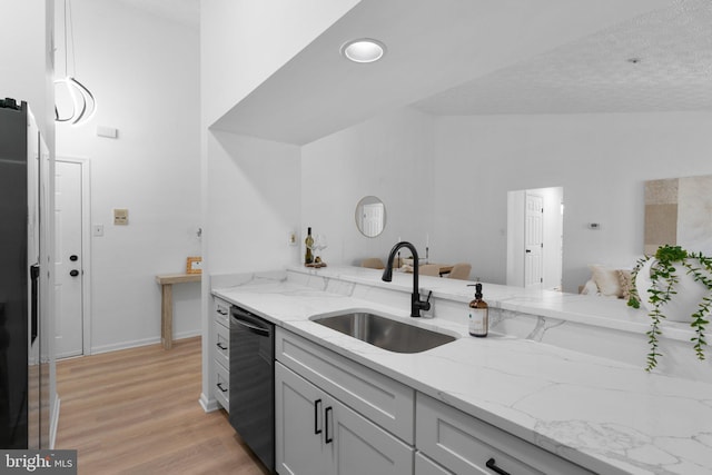1490 Greenbriar Cir Unit 1-1490, Pikesville, MD 21208 - kitchen featuring a sink, dishwasher, light wood-style floors, and light stone counters