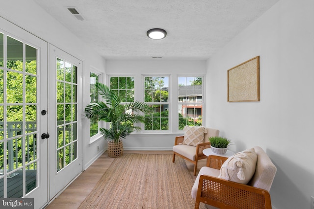 1490 Greenbriar Cir Unit 1-1490, Pikesville, MD 21208 - sunroom featuring french doors, wood finished floors, and a textured ceiling