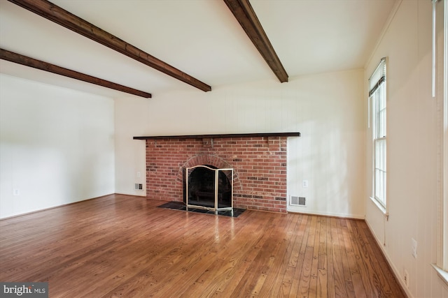 1881 Cold Creek Ct, Vienna, VA 22182 - unfurnished living room featuring hardwood / wood-style floors, a fireplace, beam ceiling, and plenty of natural light