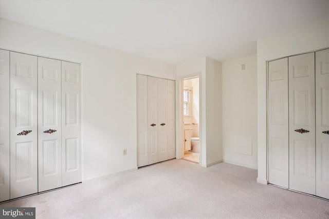 1881 Cold Creek Ct, Vienna, VA 22182 - unfurnished bedroom featuring two closets, light colored carpet, and baseboards